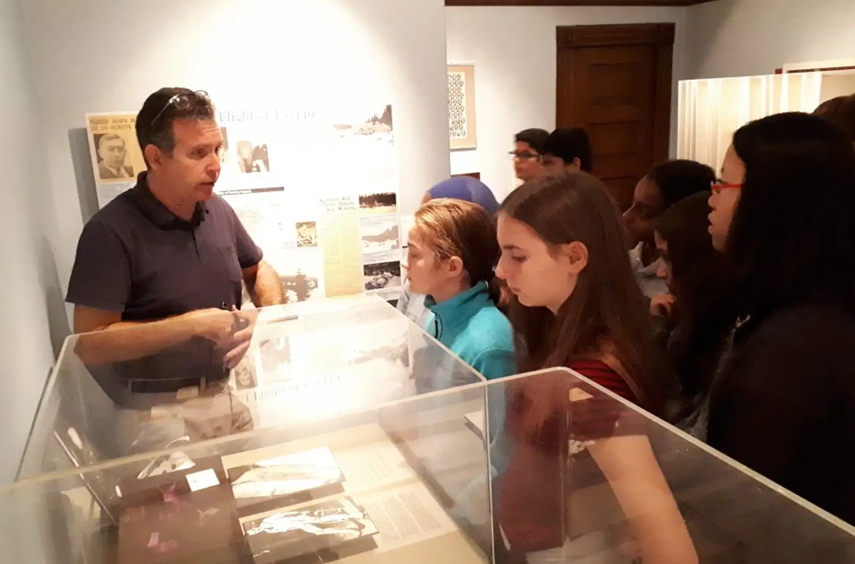 a group of people looking at a display case