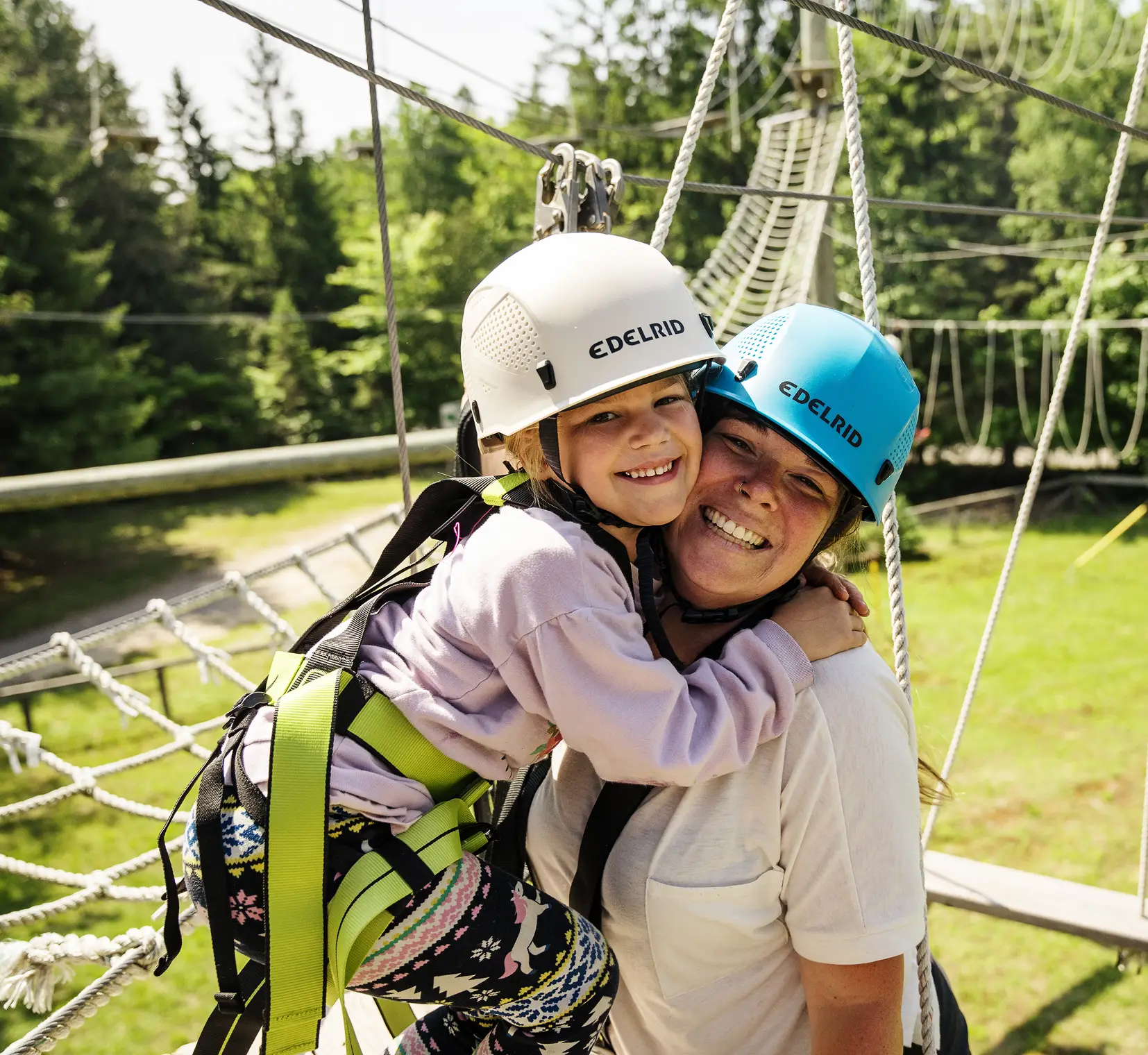 a woman and a child wearing helmets