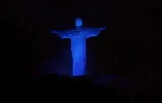 a statue of a man in a blue light