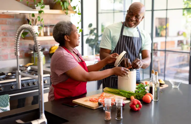 a man and woman in a kitchen