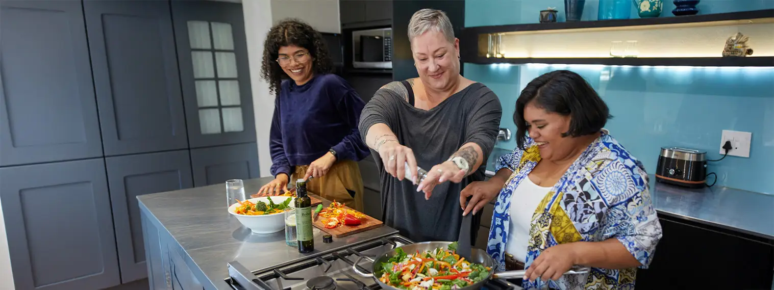 a group of women cooking in a kitchen