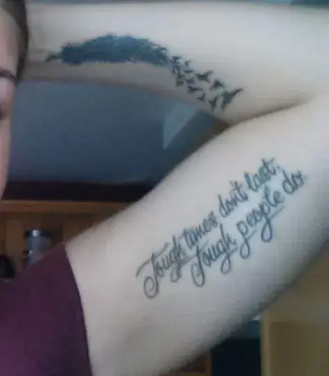 a person with tattoos on their arm