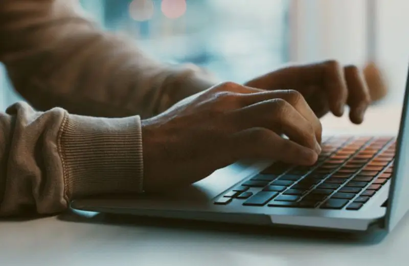 a person typing on a laptop