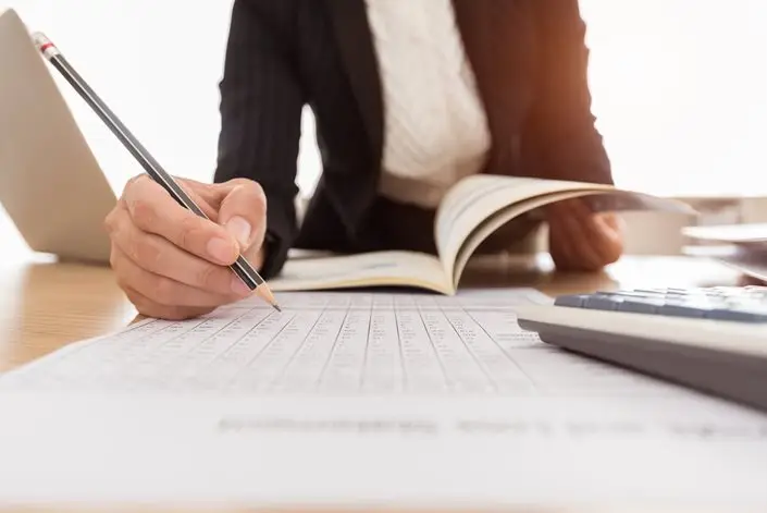 a person writing on a book