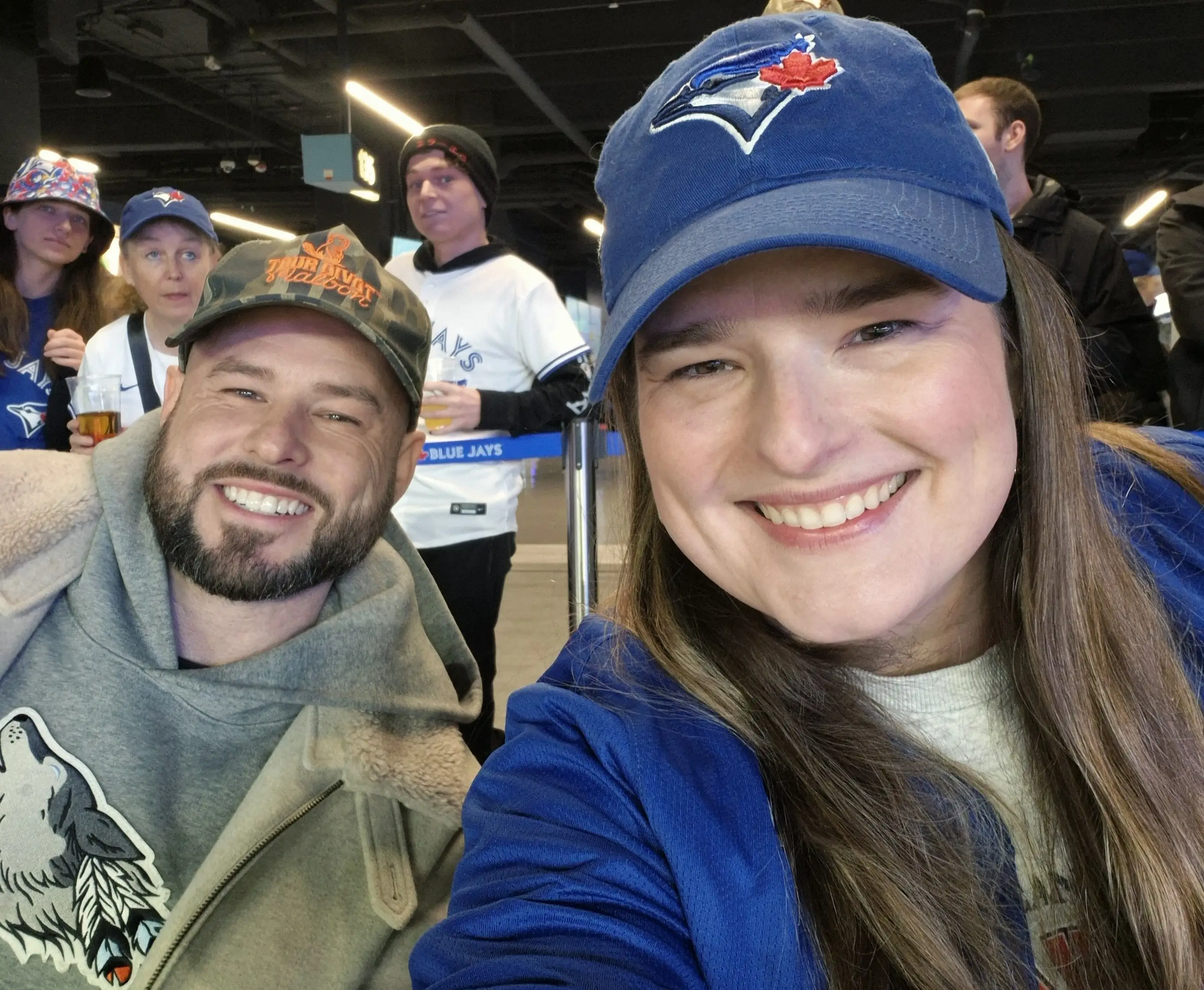 a selfie of a woman and a man in a blue hat