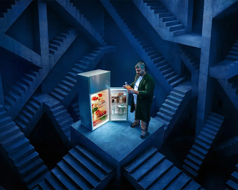 a man standing in front of a refrigerator