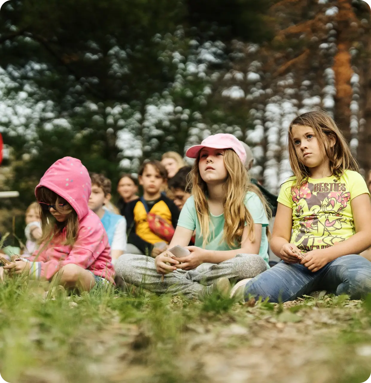 a group of children sitting on the ground