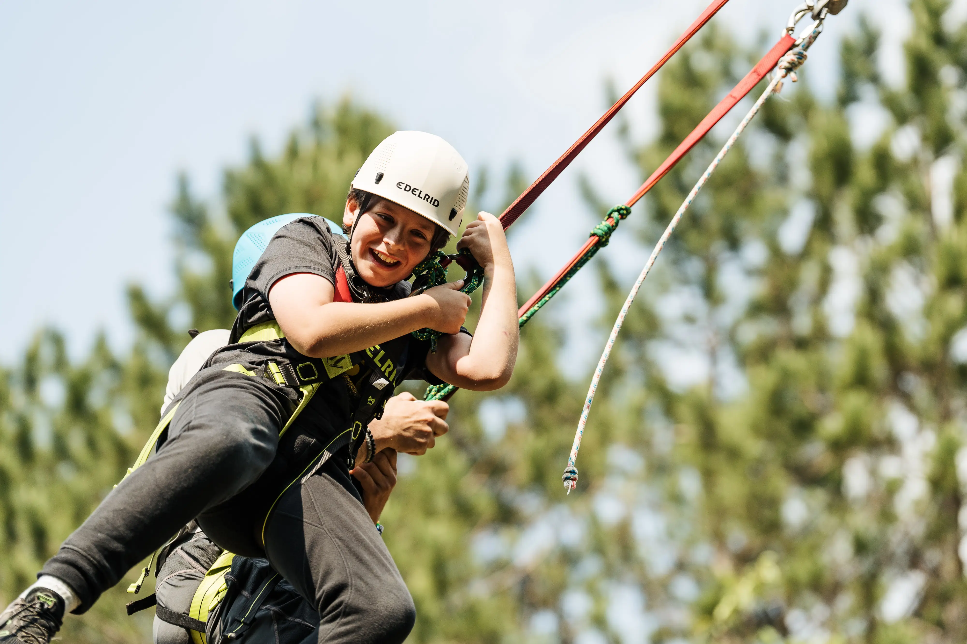 a person in a harness holding another person in the air