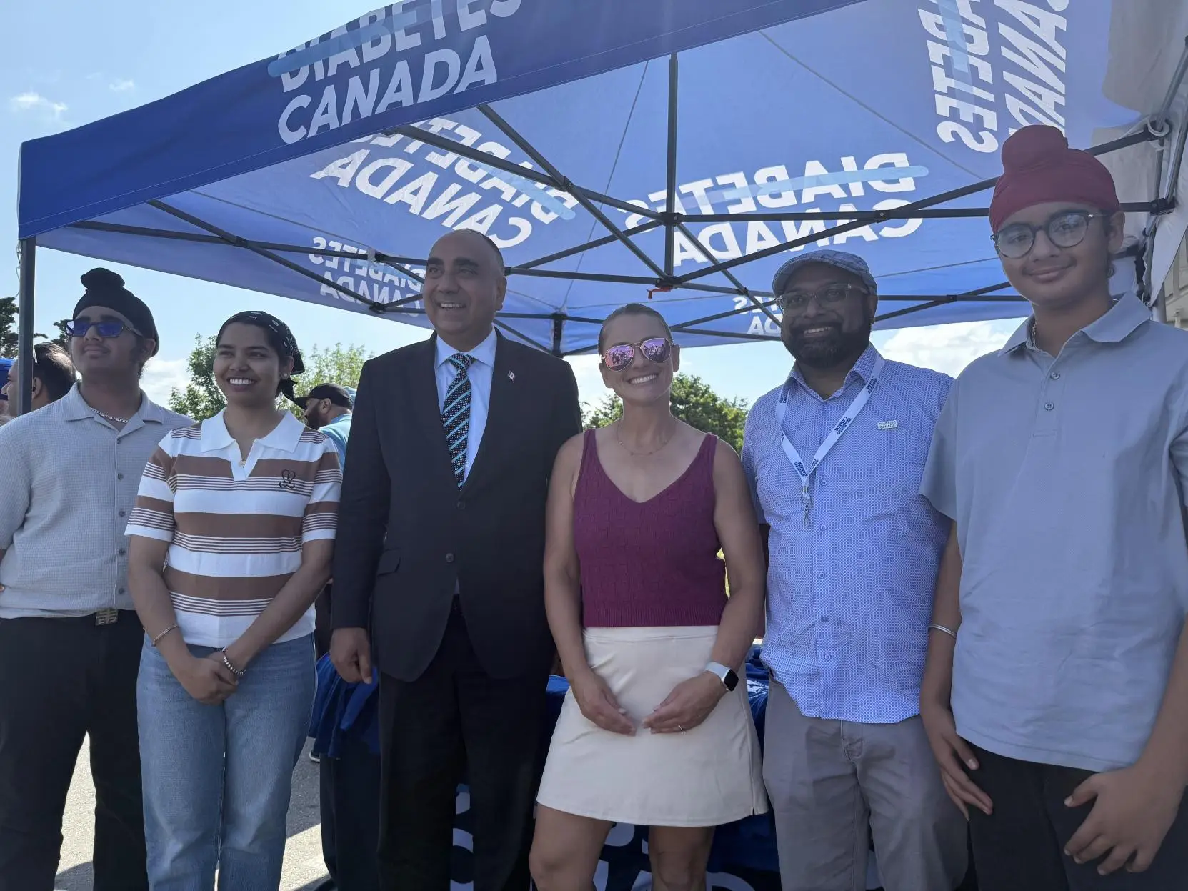 a group of people standing under a tent