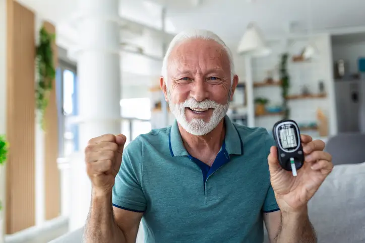 a man holding a device with a fist up