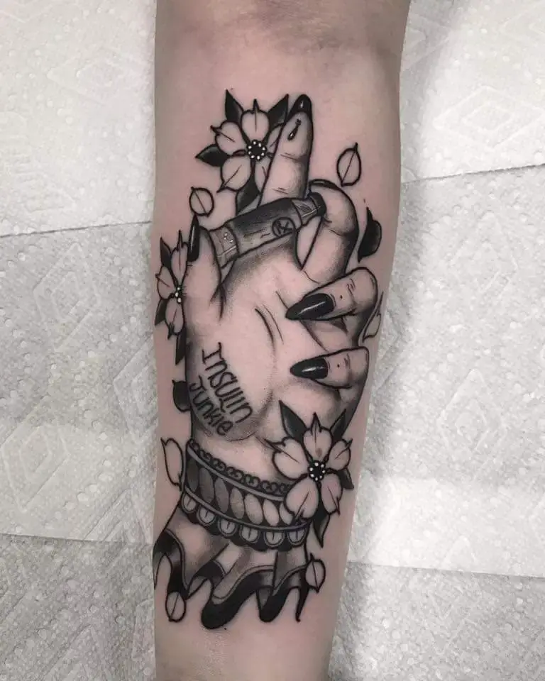 a tattoo of a hand holding a pencil