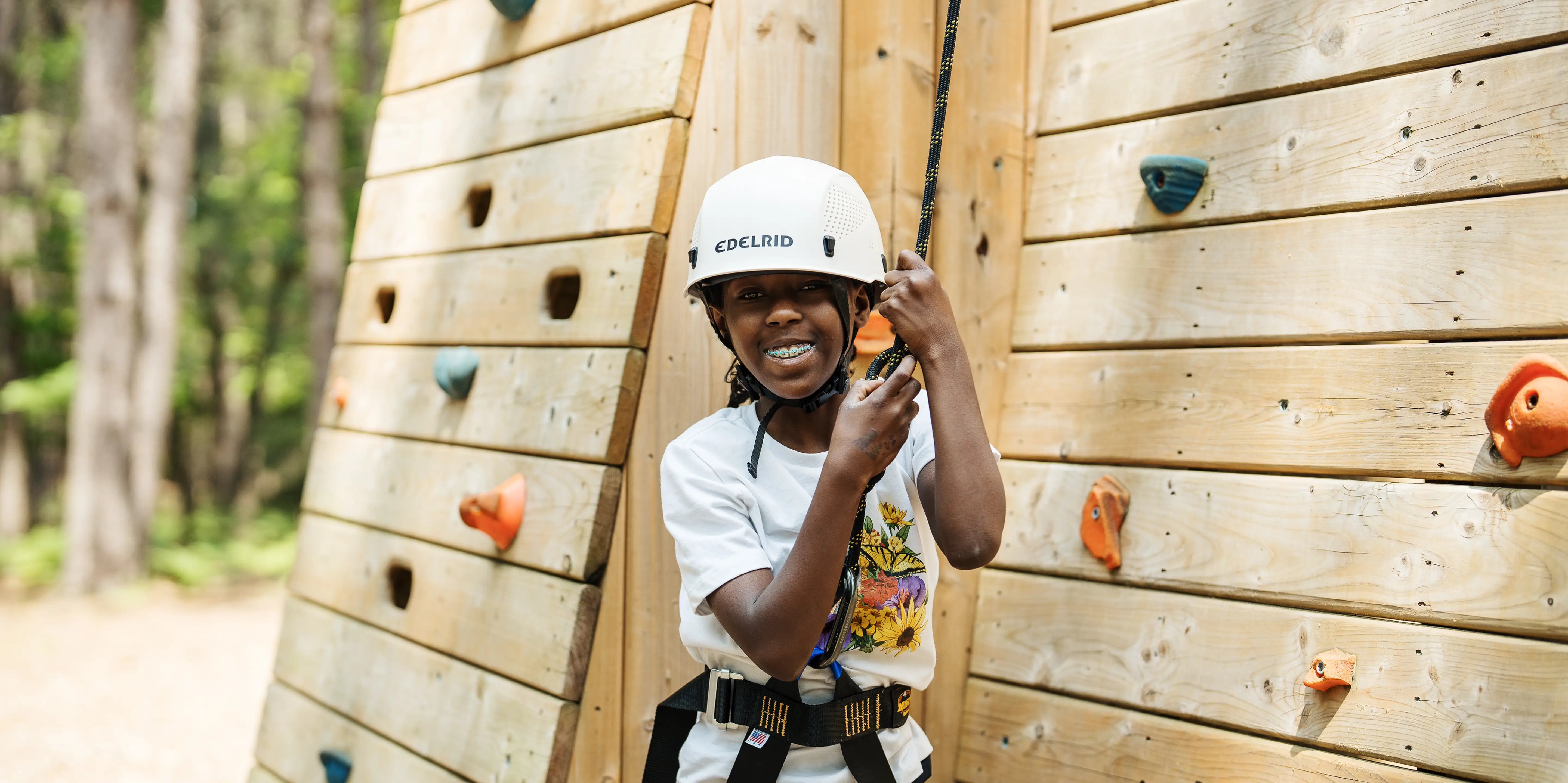 a girl wearing a helmet and harness