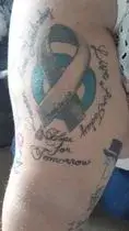 a person's arm with tattoos