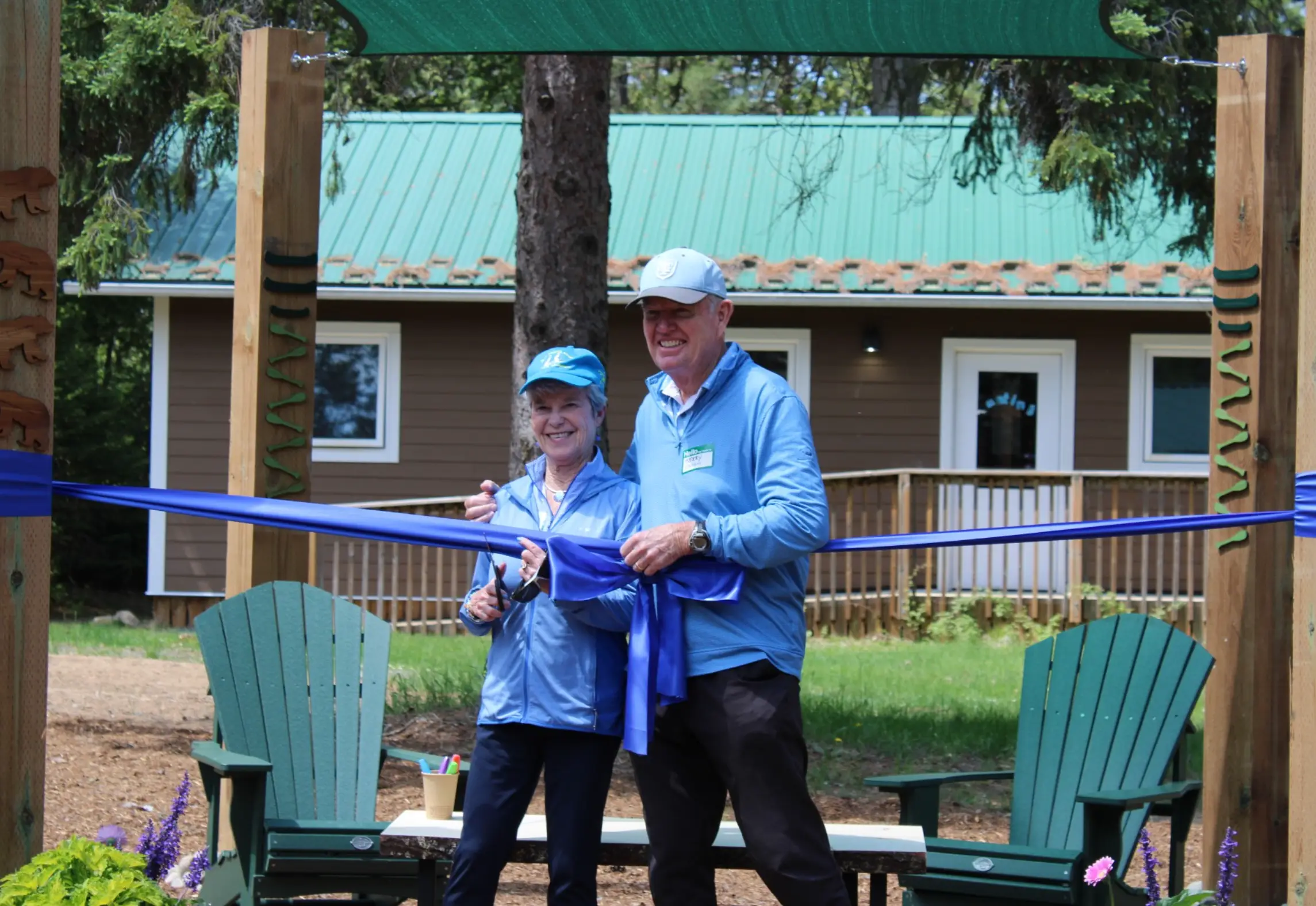 a man and woman holding a blue ribbon