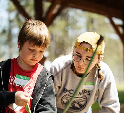 a boy and girl looking at plants