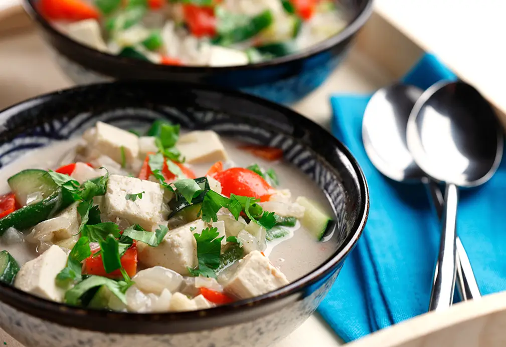 a bowl of soup with vegetables and tofu