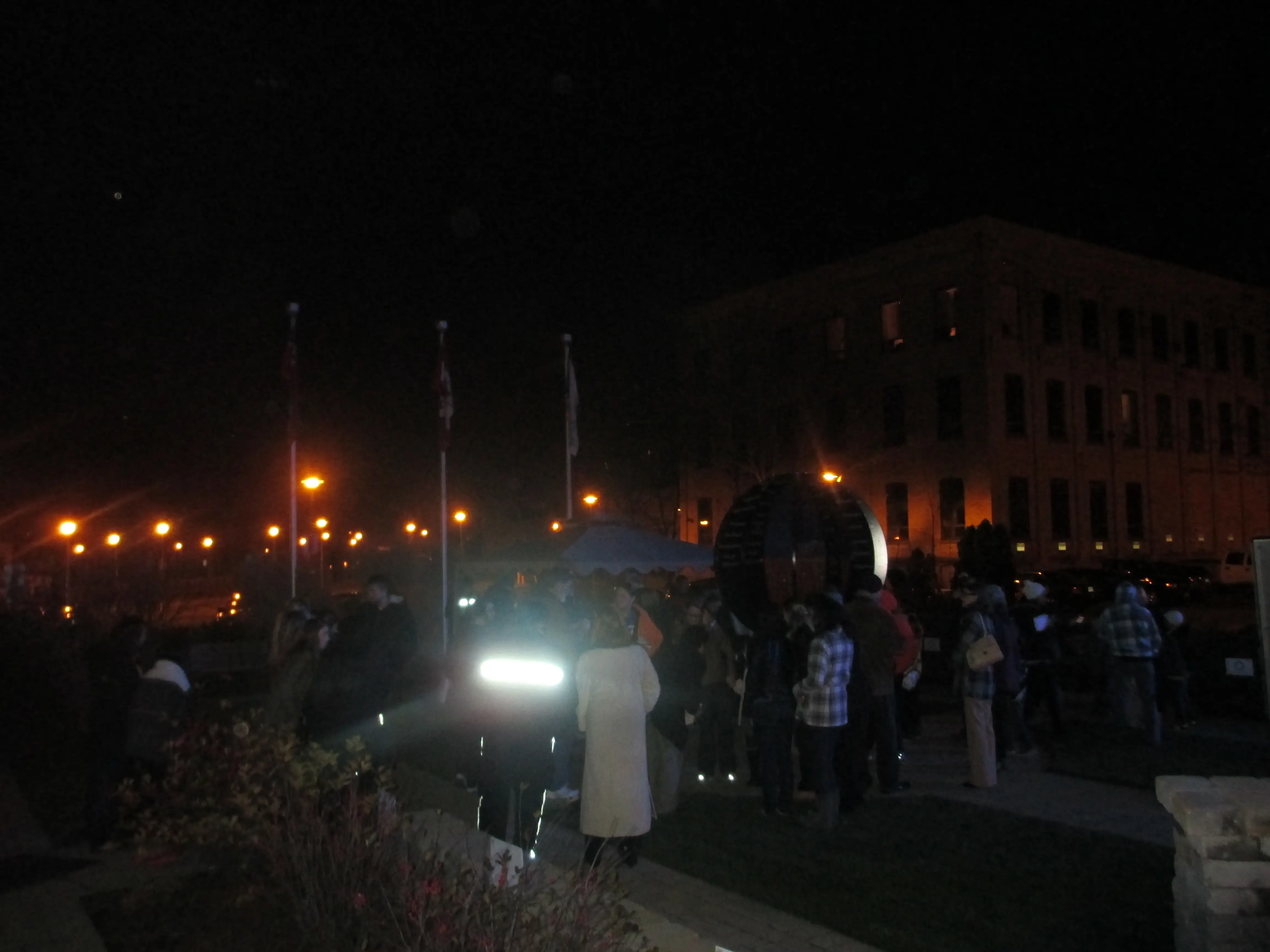 a group of people standing outside at night
