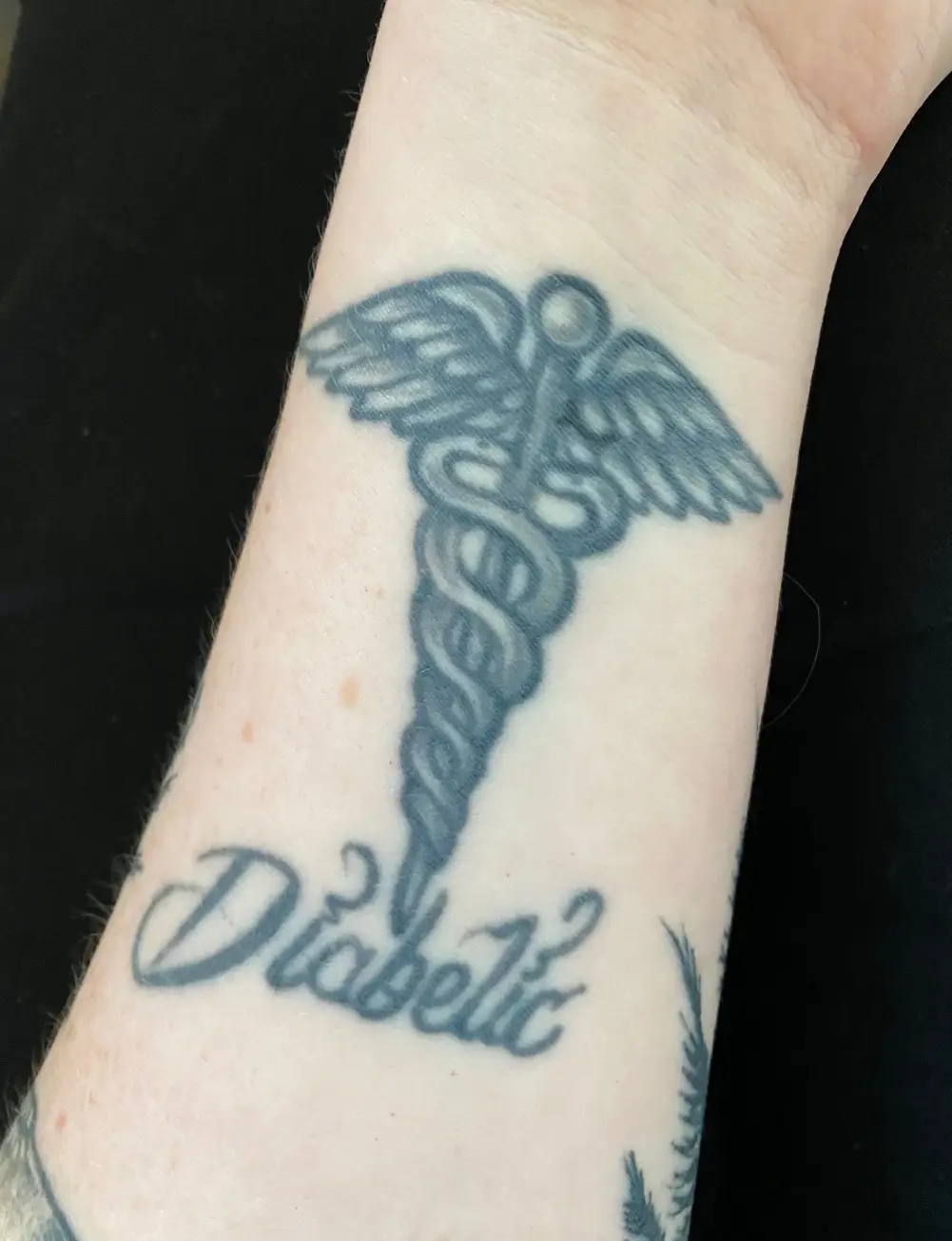 a tattoo on a person's wrist