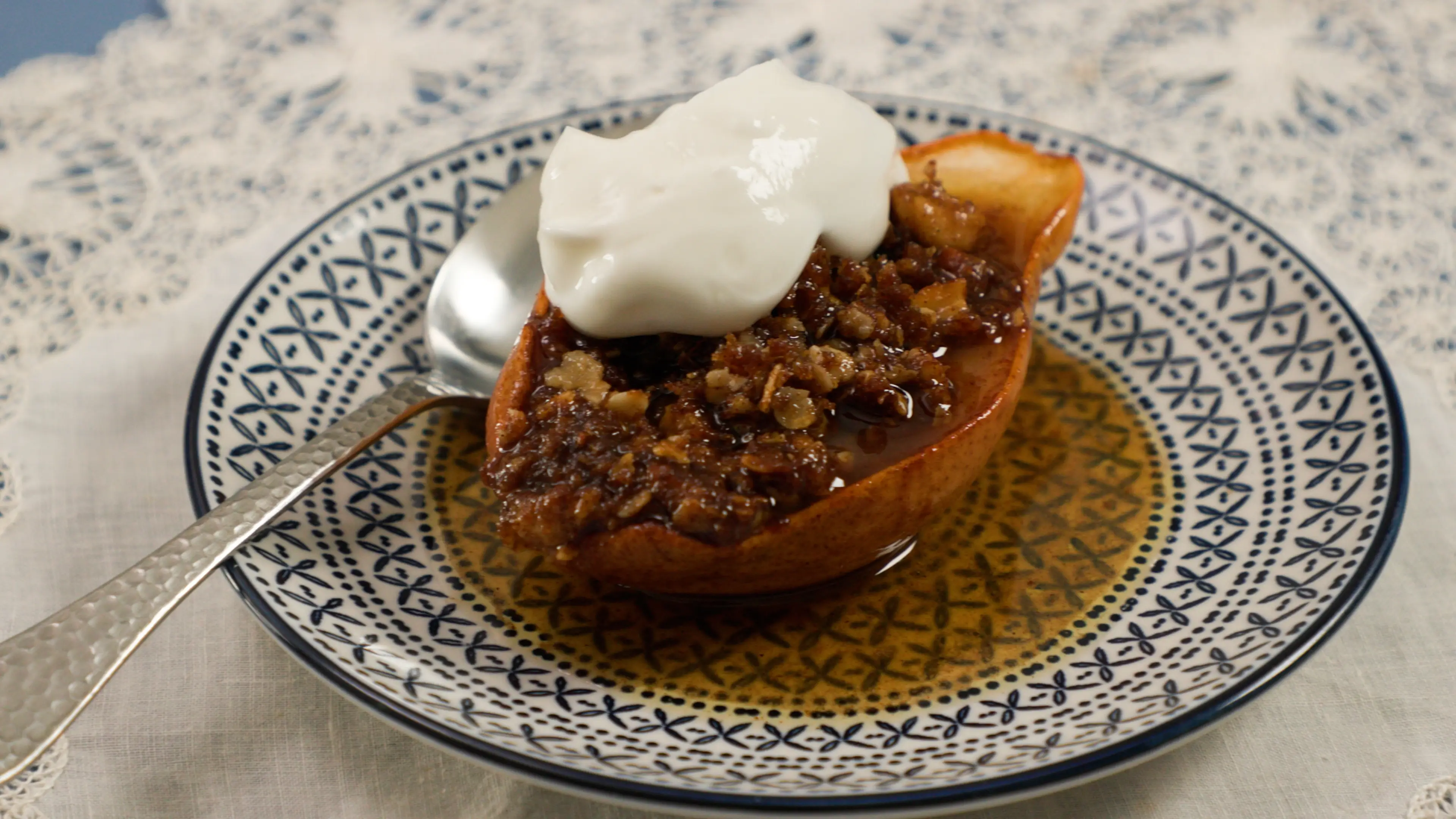 a pear with a spoon on a plate