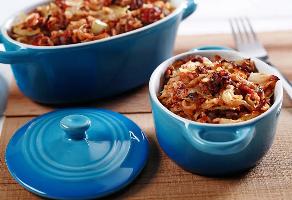 two blue bowls with food in them