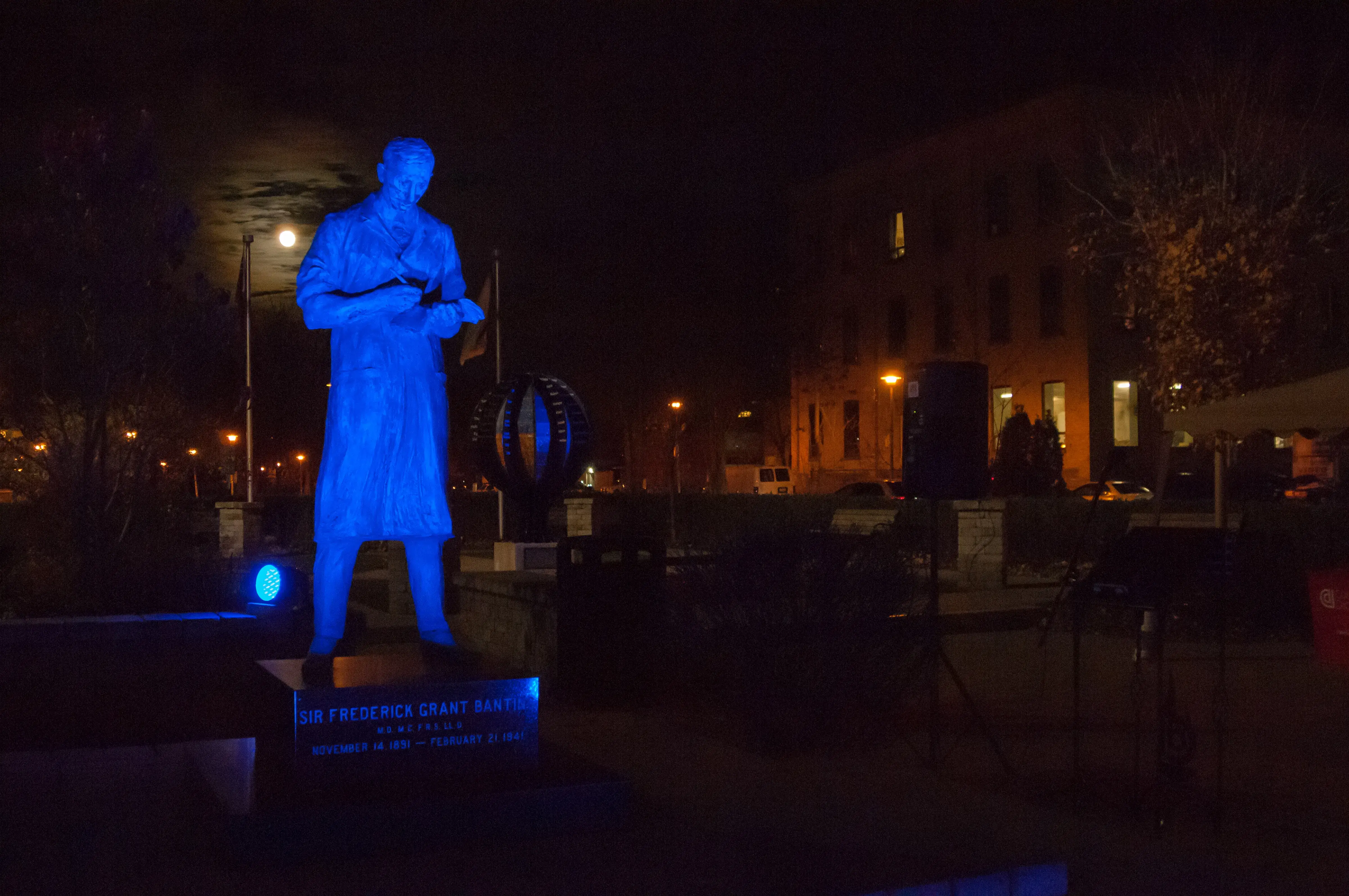 a blue statue of a man in a blue light