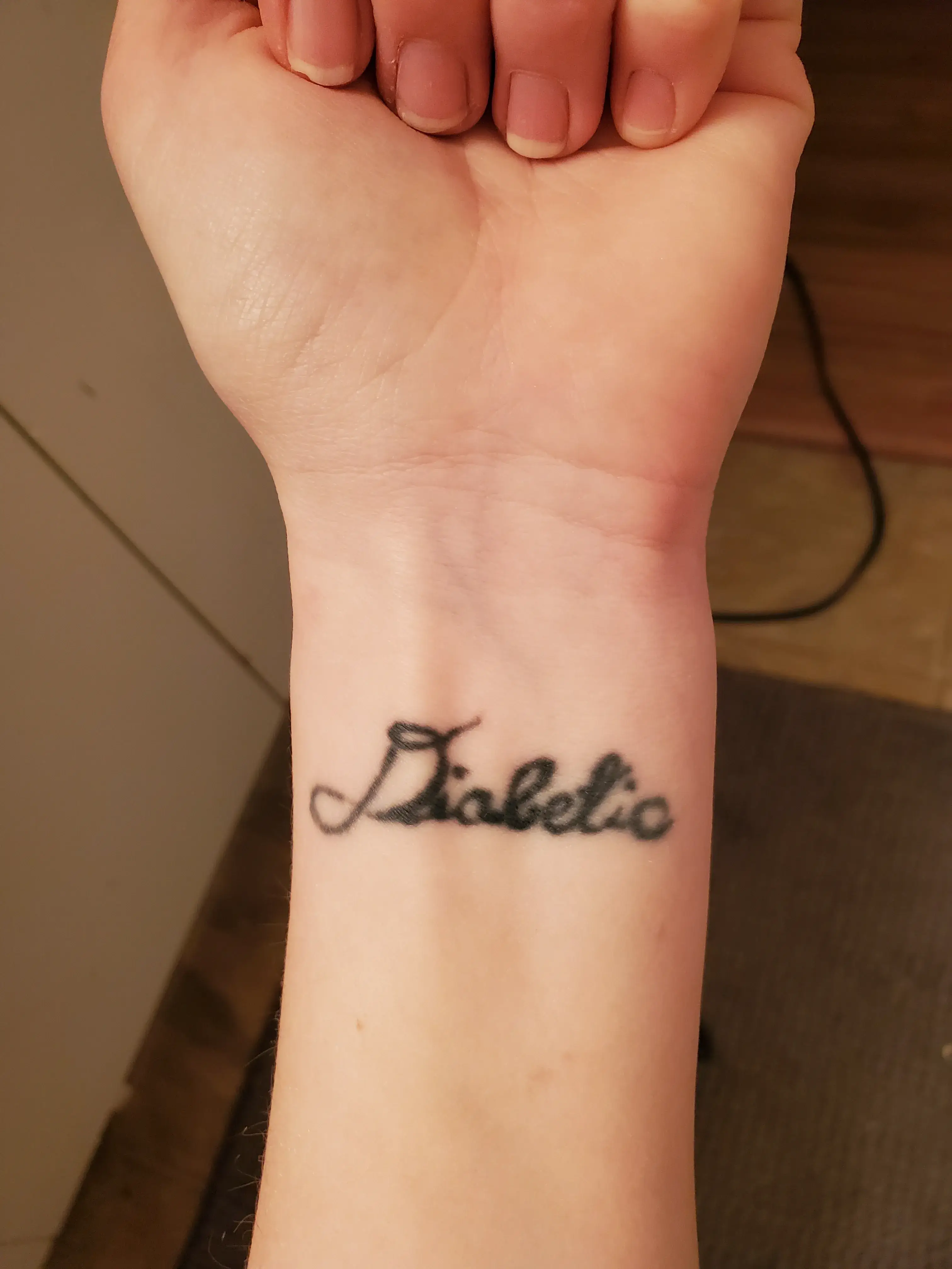 a person's wrist with a tattoo