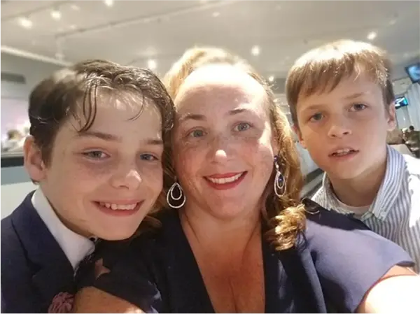 a woman and two boys taking a selfie