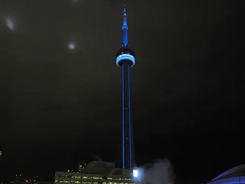 a tall tower with blue lights at night