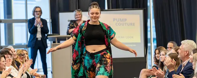 a woman wearing a colorful shirt and shorts