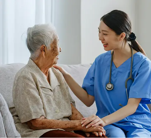 a nurse holding an old woman's hand