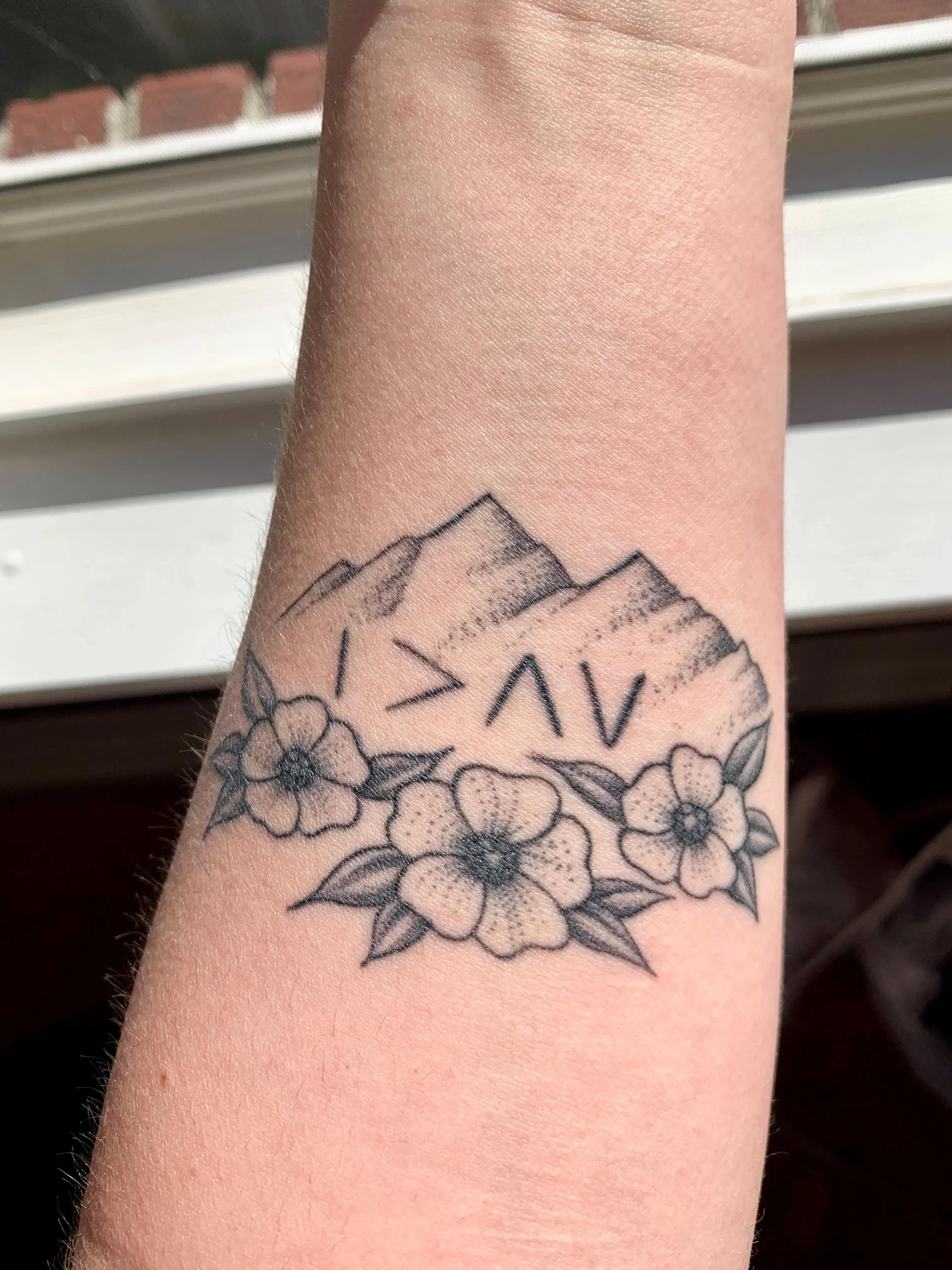 a tattoo on a wrist