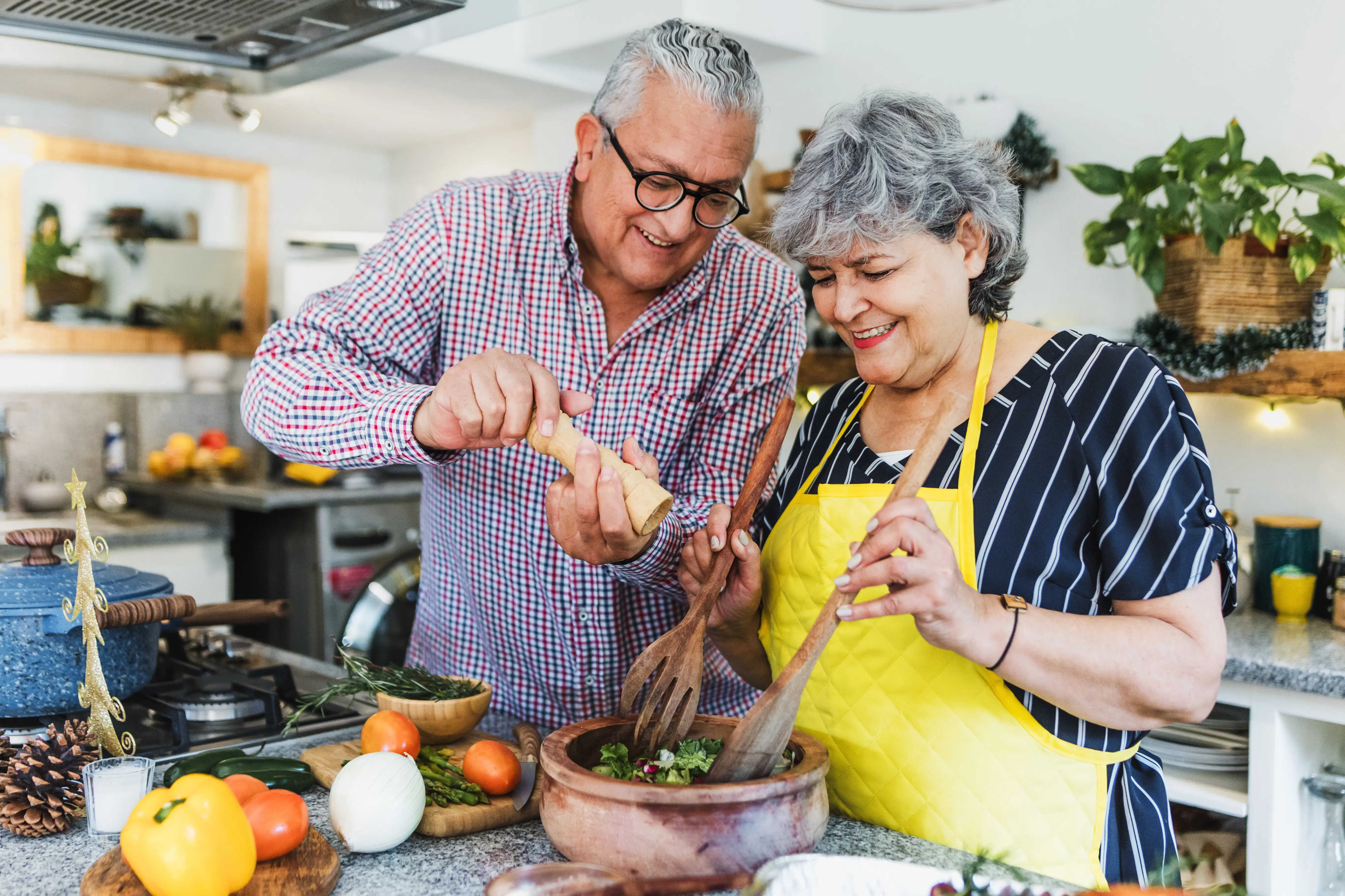 a man and woman cooking in a kitchen