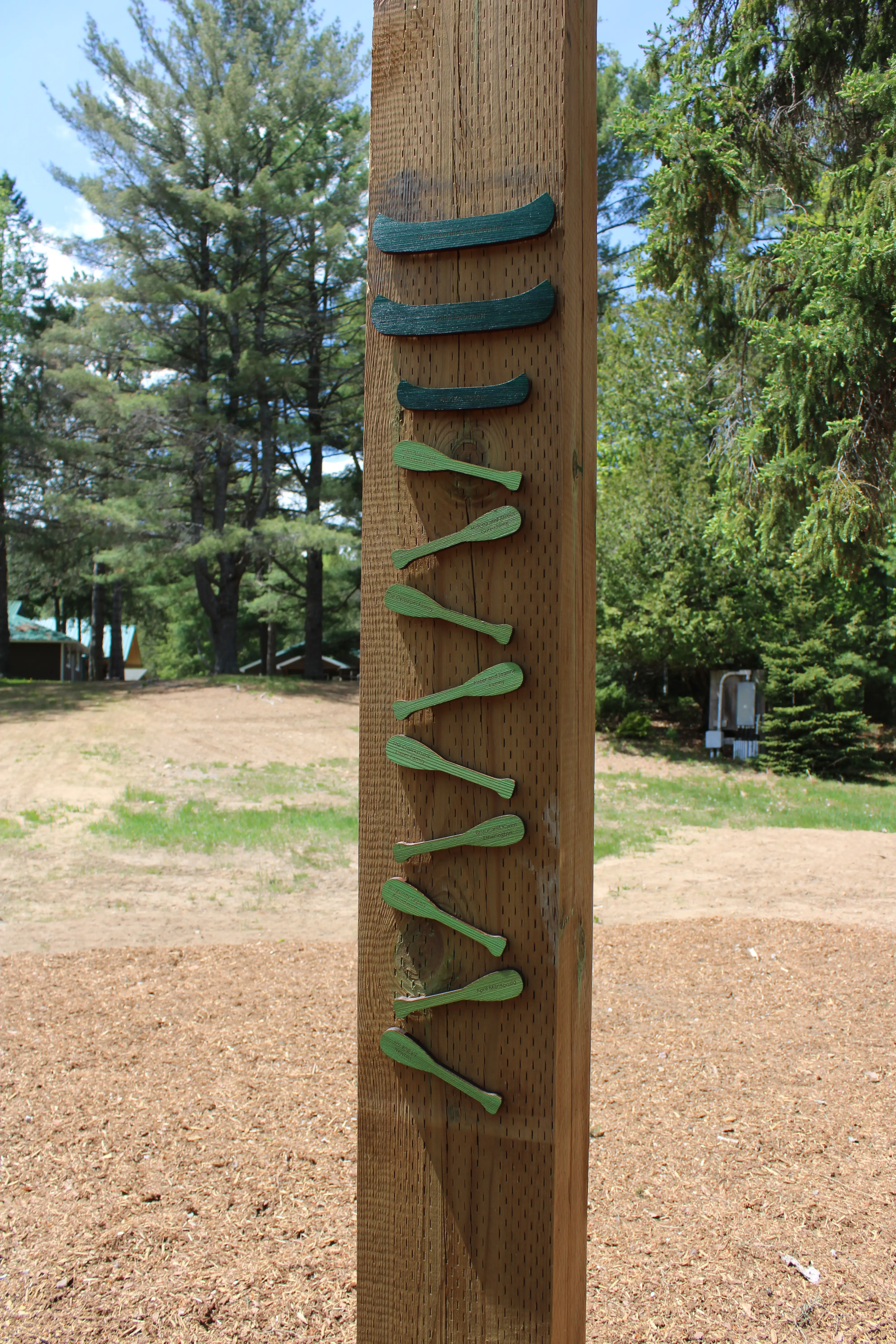 a wooden post with sticks attached to it