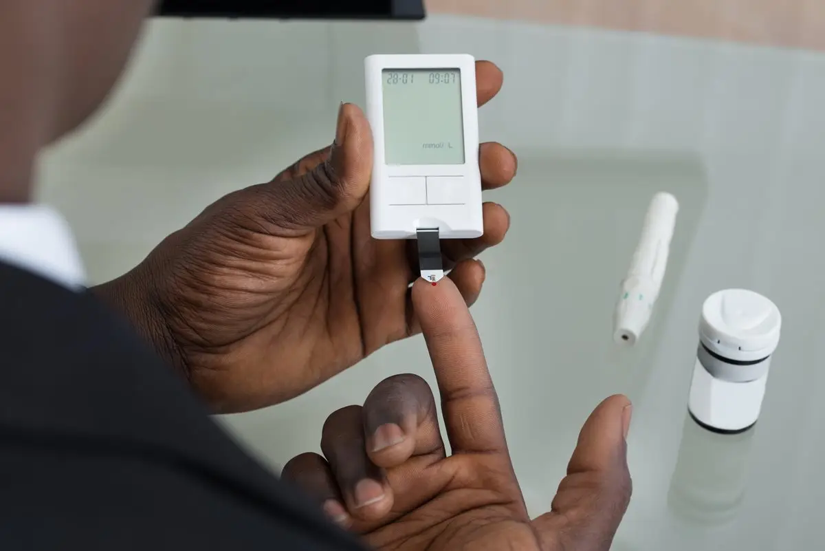 a person using a finger blood sugar test