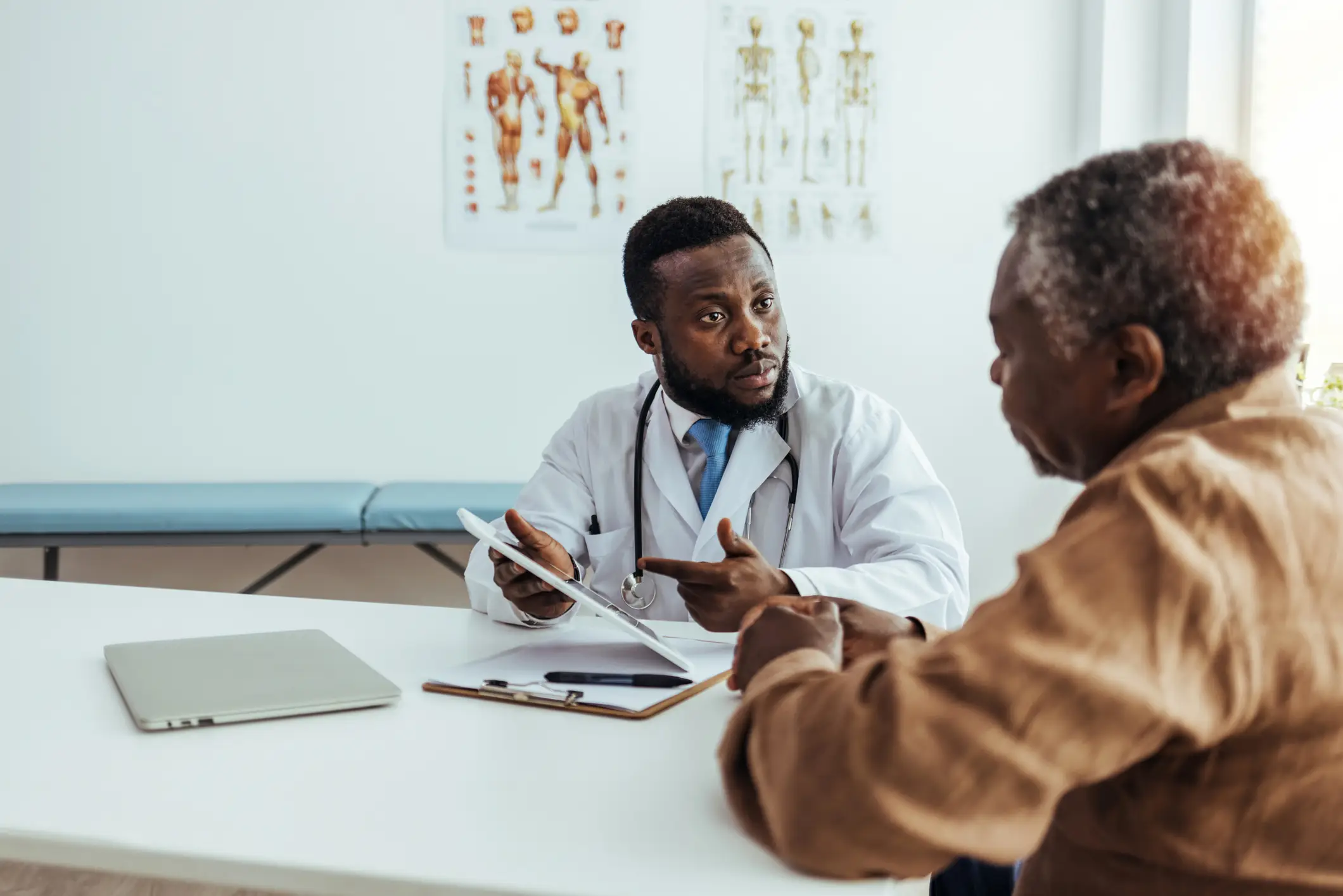 a man in a white coat talking to a man in a white coat