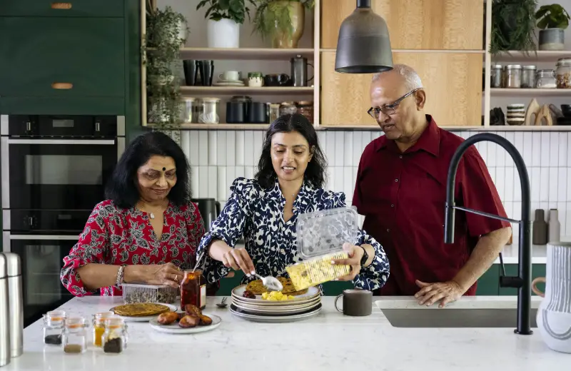a group of people sitting at a table with food