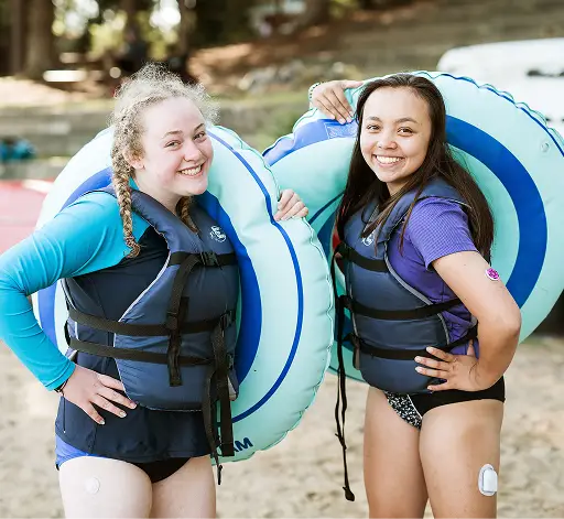 two women wearing life jackets and standing next to each other