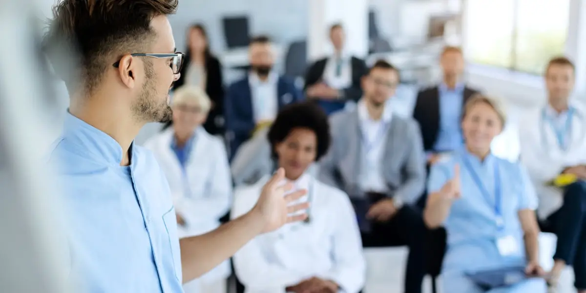 a man speaking to a group of people