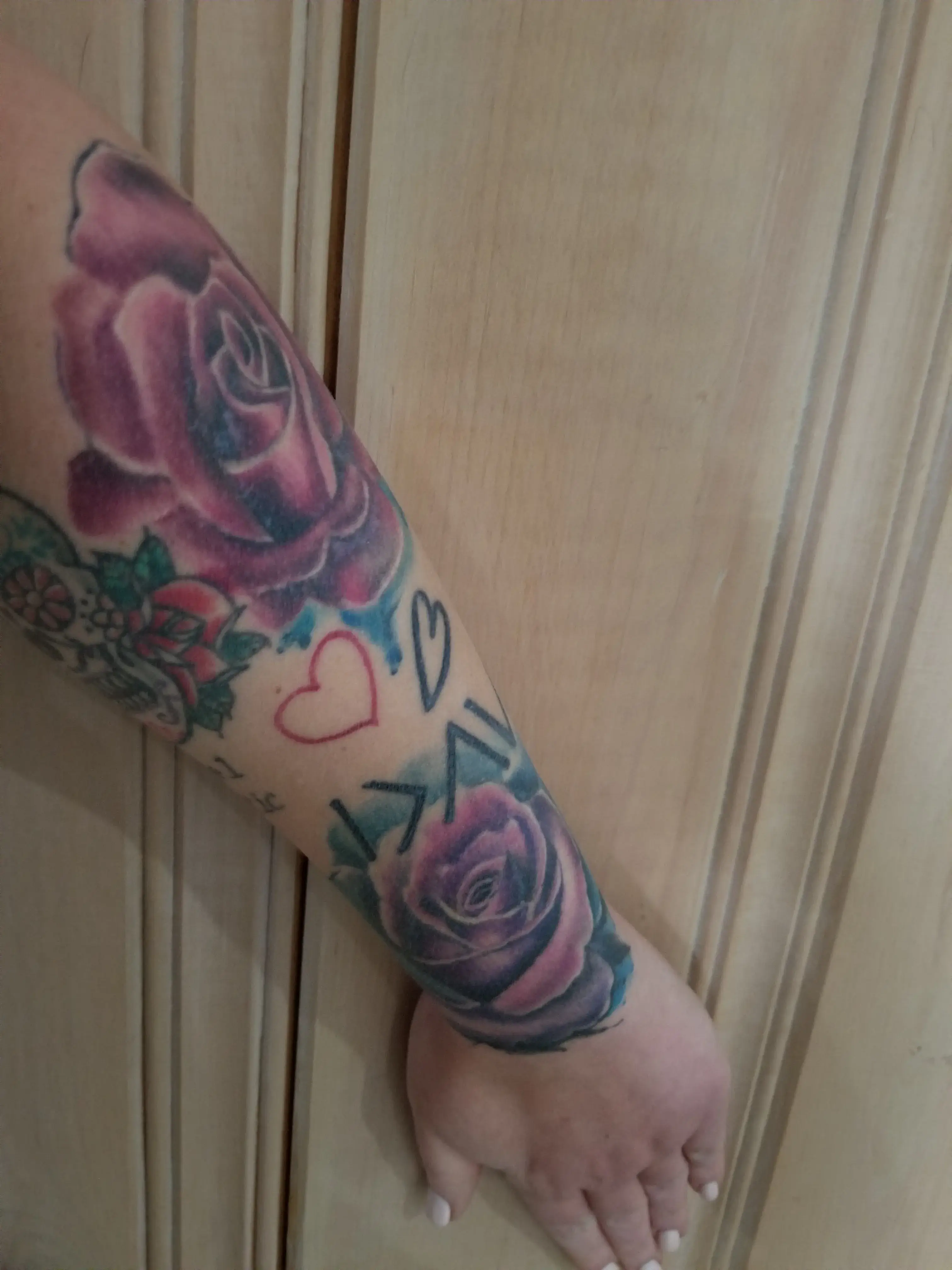 a person's arm with tattoos