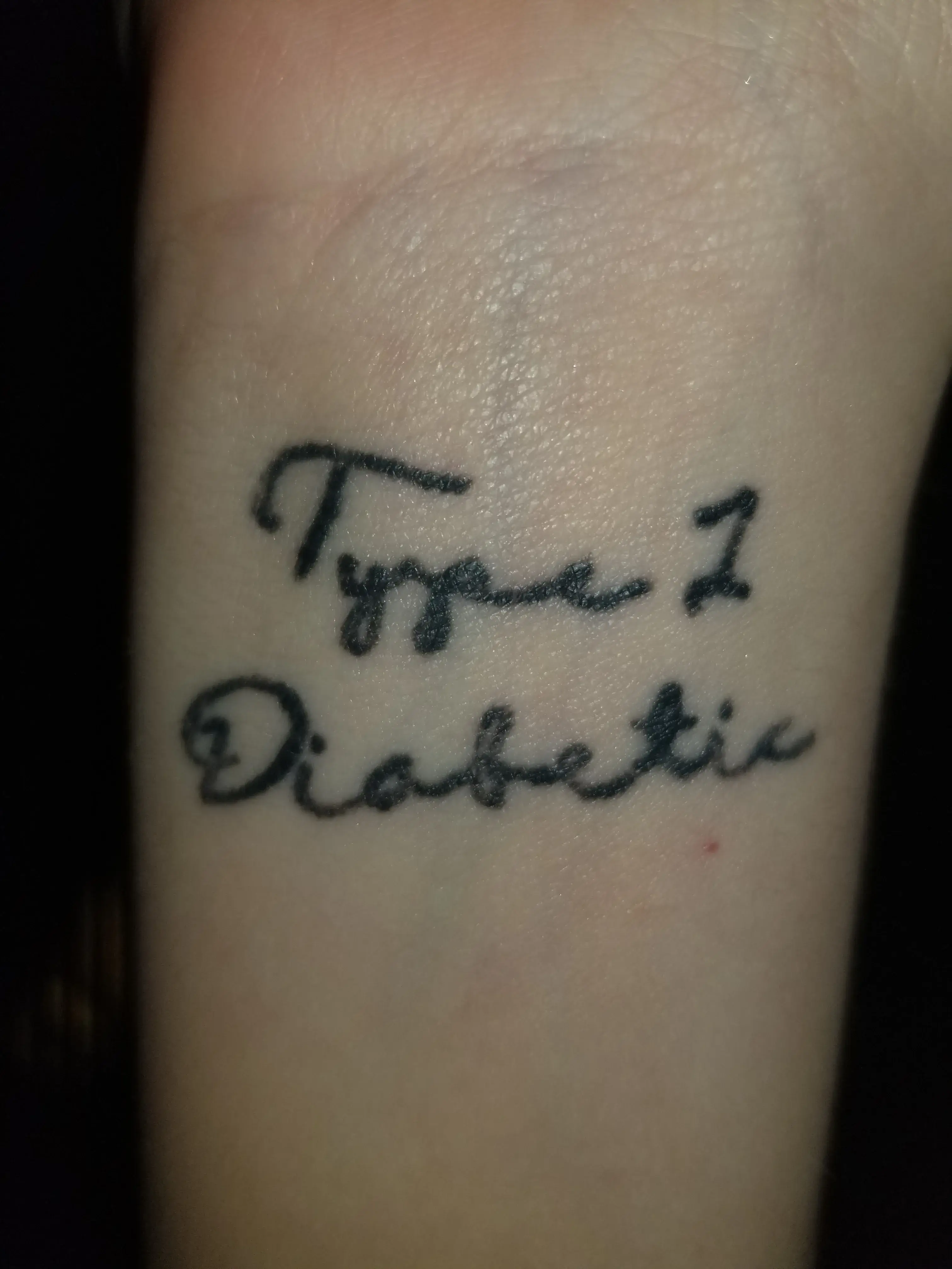 a close up of a tattoo on a wrist