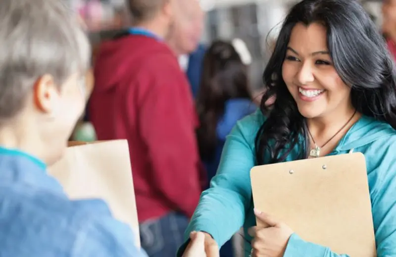 a woman shaking hands with another woman
