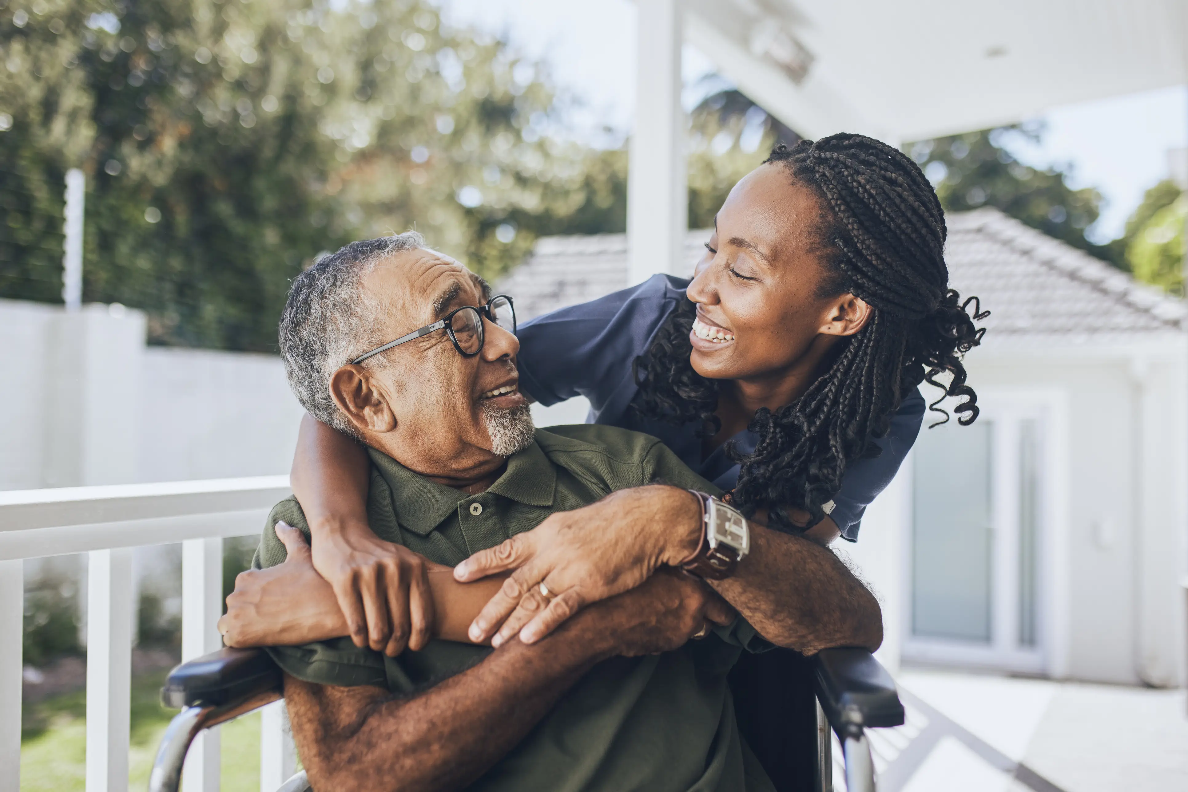 a woman hugging a man in a wheelchair