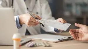 a person holding a pen and paper