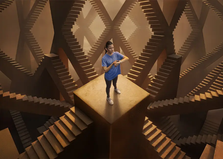 a woman standing on a square platform surrounded by stairs