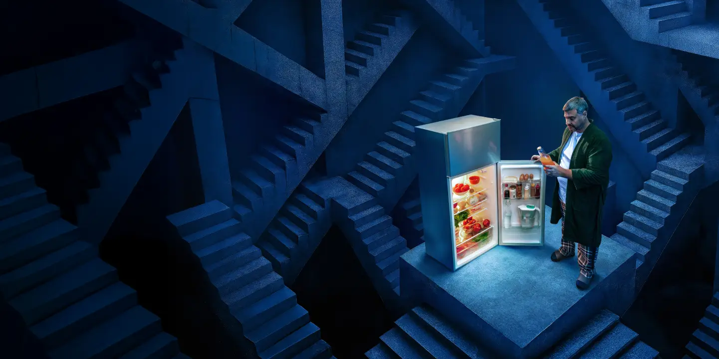a person standing next to a refrigerator