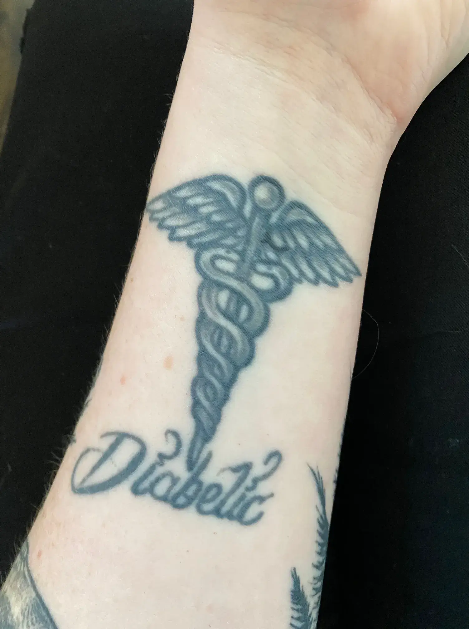 a tattoo on a person's wrist