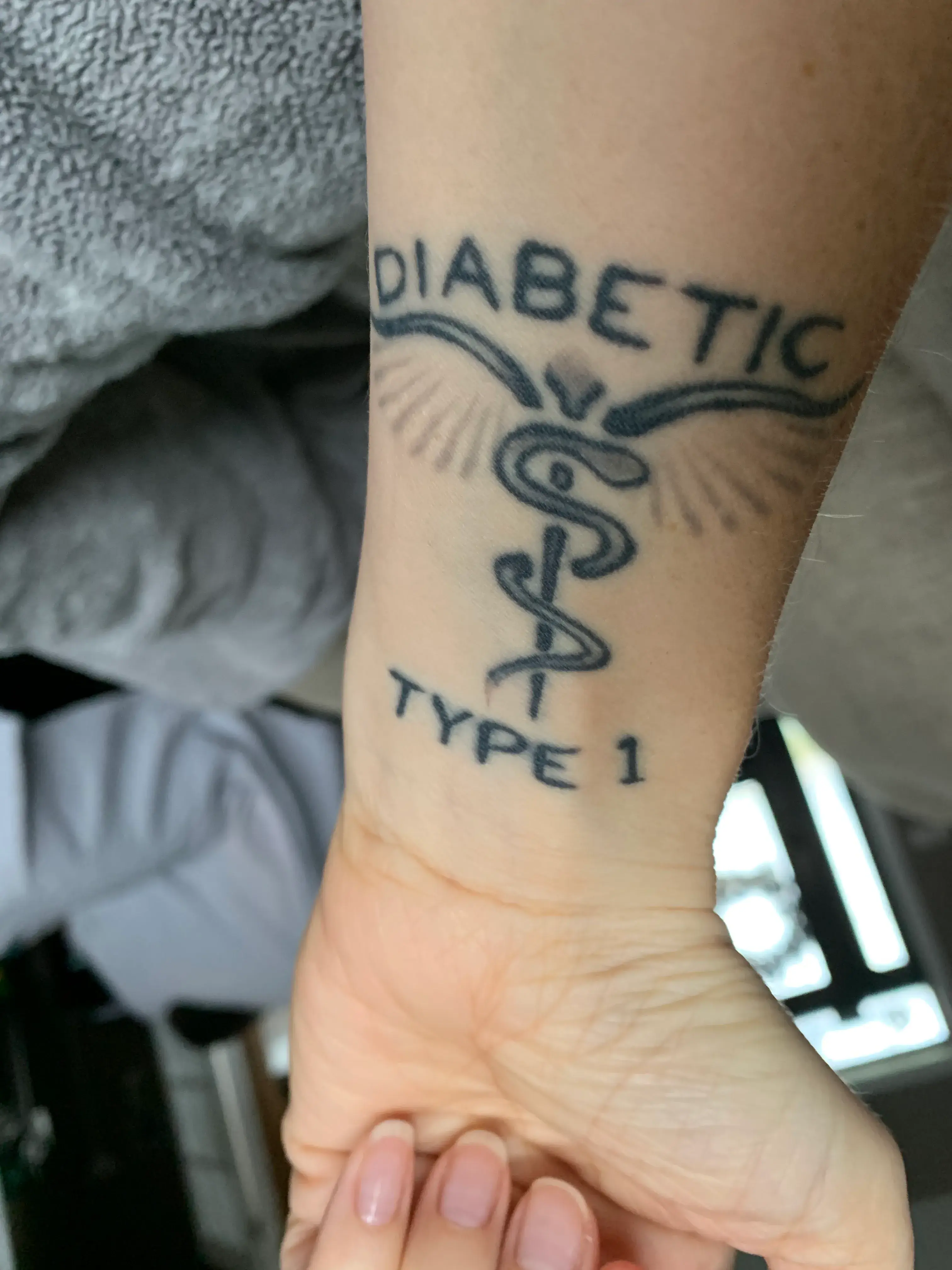a person's wrist with a tattoo