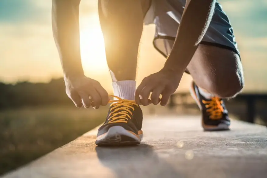 a person tying his shoelaces