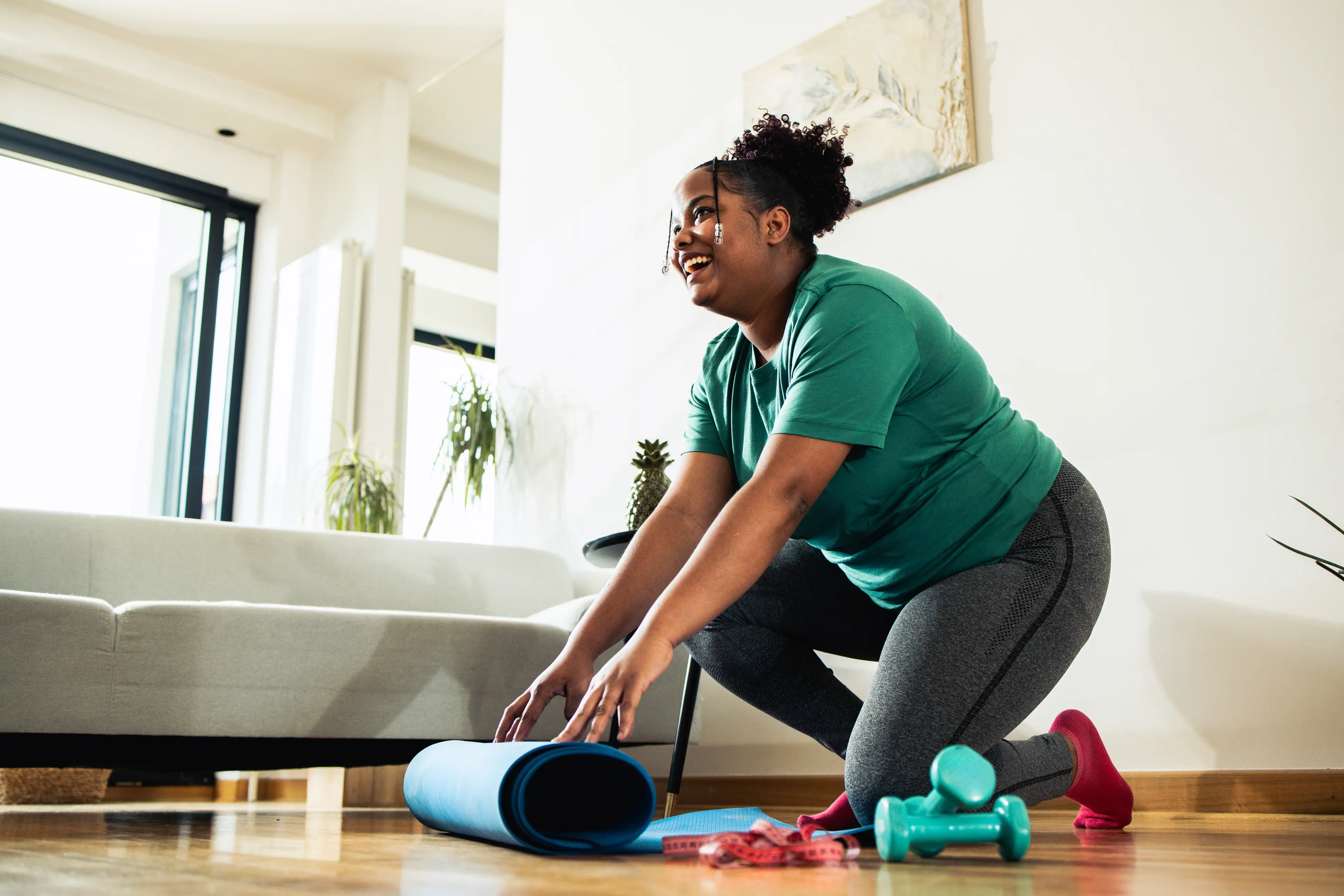 a woman rolling a yoga mat