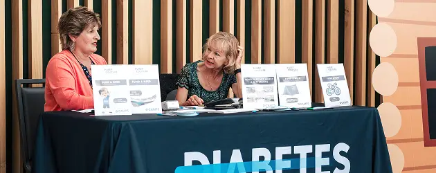 a woman sitting at a table with a table with papers